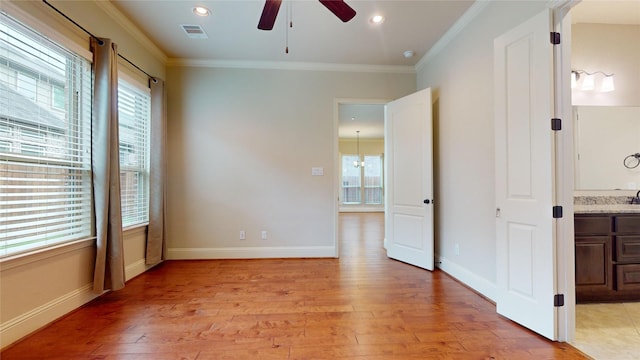 spare room featuring light hardwood / wood-style flooring, ornamental molding, and ceiling fan