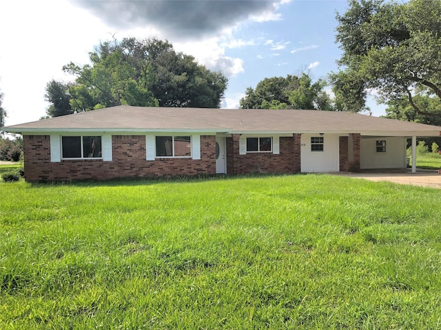 ranch-style home with brick siding, driveway, and a front lawn