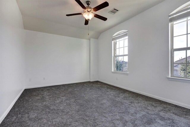 carpeted empty room with ceiling fan and lofted ceiling