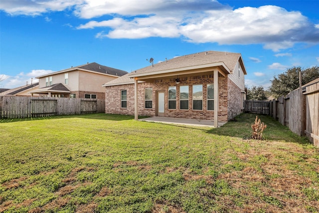 rear view of property with a yard and a patio area