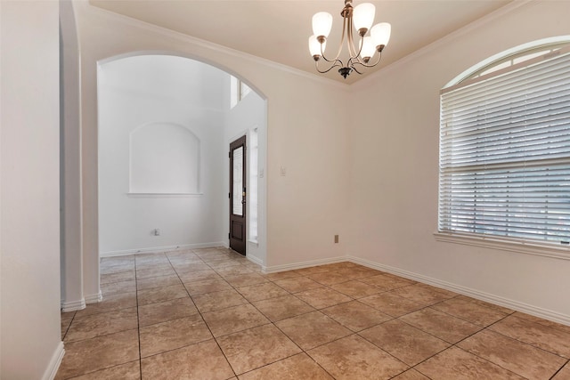 tiled empty room featuring ornamental molding and an inviting chandelier