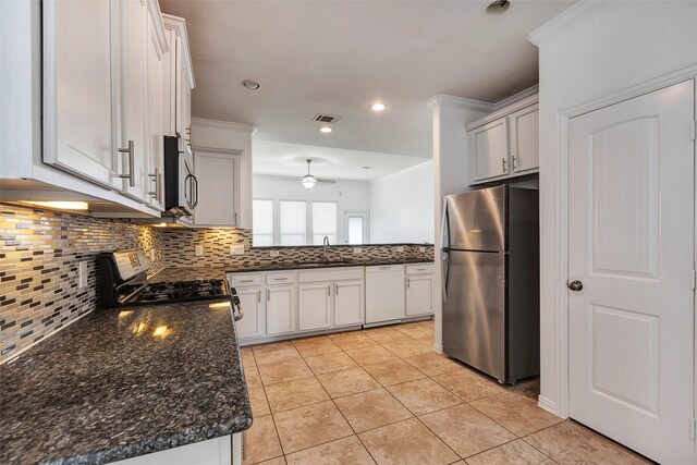 kitchen with sink, white cabinetry, light tile patterned floors, appliances with stainless steel finishes, and decorative backsplash