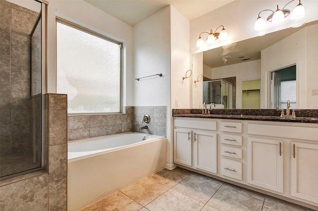 bathroom featuring vanity, tile patterned floors, and plus walk in shower