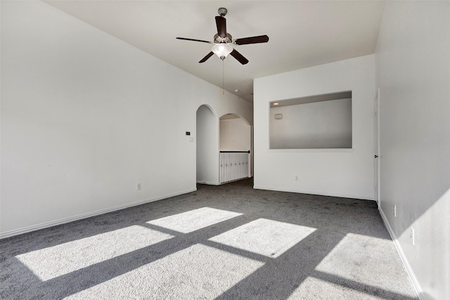 unfurnished room with ceiling fan and carpet