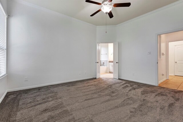 spare room featuring crown molding, light colored carpet, and ceiling fan