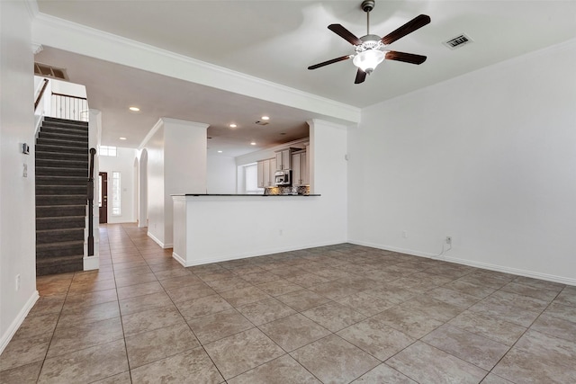 unfurnished living room with light tile patterned floors, ornamental molding, and ceiling fan