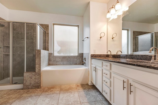 bathroom featuring vanity, tile patterned floors, independent shower and bath, and a healthy amount of sunlight