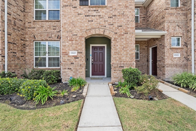 doorway to property with a lawn