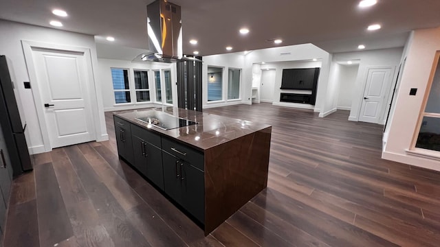 kitchen featuring island range hood, dark wood-type flooring, black appliances, and a center island