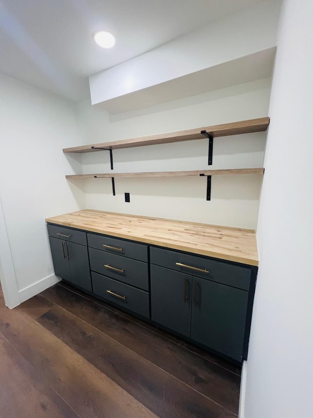 bar featuring dark wood-type flooring and butcher block countertops