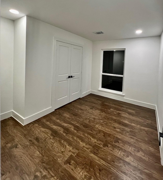 spare room with dark hardwood / wood-style flooring