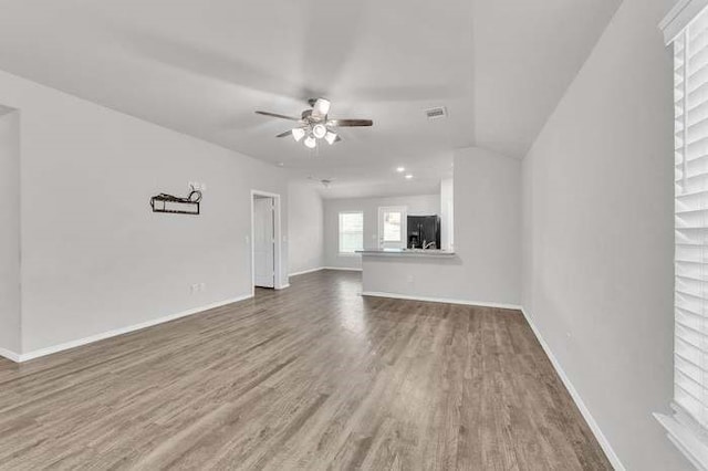 unfurnished living room with hardwood / wood-style floors and ceiling fan