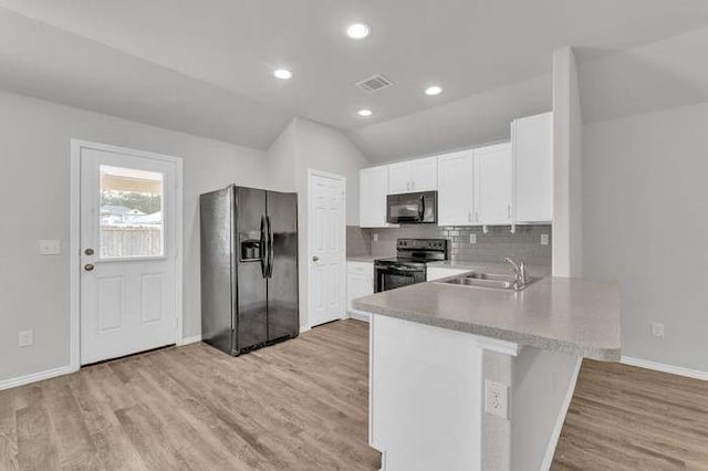 kitchen with white cabinetry, light hardwood / wood-style flooring, and black appliances