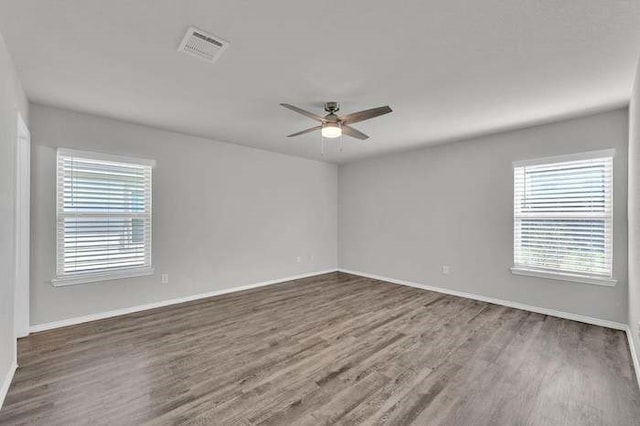 unfurnished room featuring ceiling fan and dark hardwood / wood-style floors