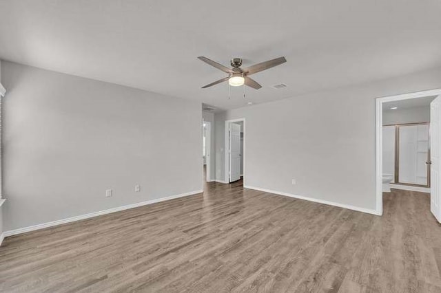 empty room featuring hardwood / wood-style flooring and ceiling fan