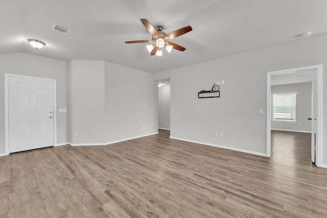 unfurnished room featuring hardwood / wood-style flooring, vaulted ceiling, and ceiling fan