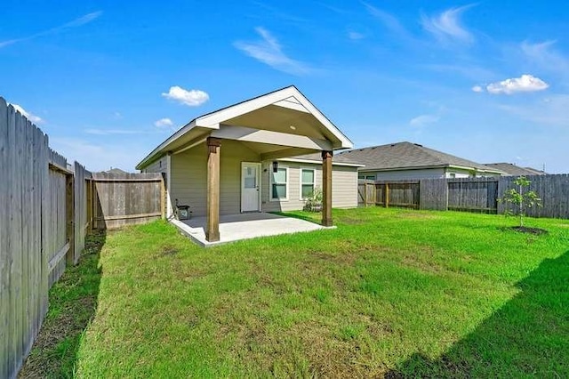 back of property featuring a patio area and a lawn