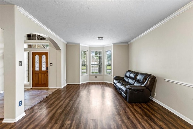 interior space with arched walkways, crown molding, visible vents, dark wood-type flooring, and a textured ceiling