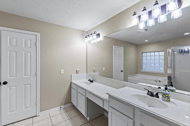 full bath featuring double vanity, visible vents, a sink, a bath, and tile patterned floors