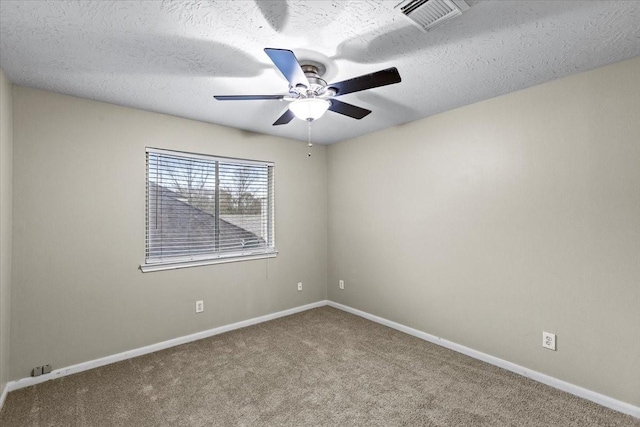 empty room with light carpet, a textured ceiling, visible vents, and baseboards