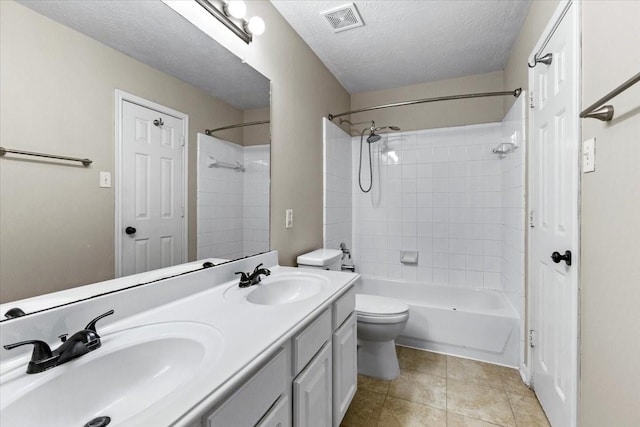 bathroom with visible vents, a sink, toilet, and double vanity