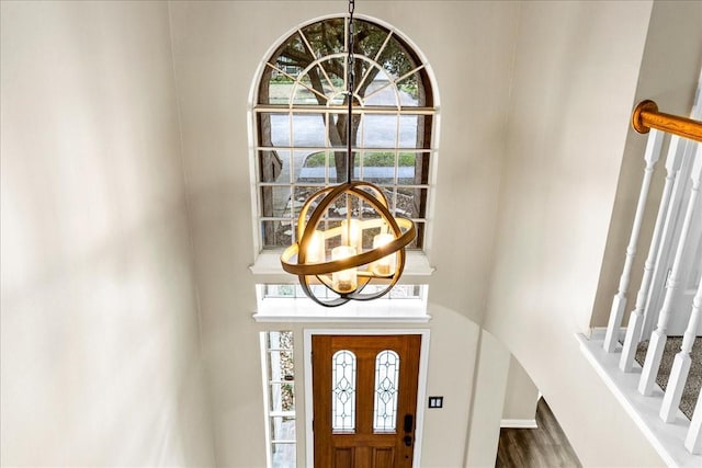 entrance foyer featuring an inviting chandelier and stairway