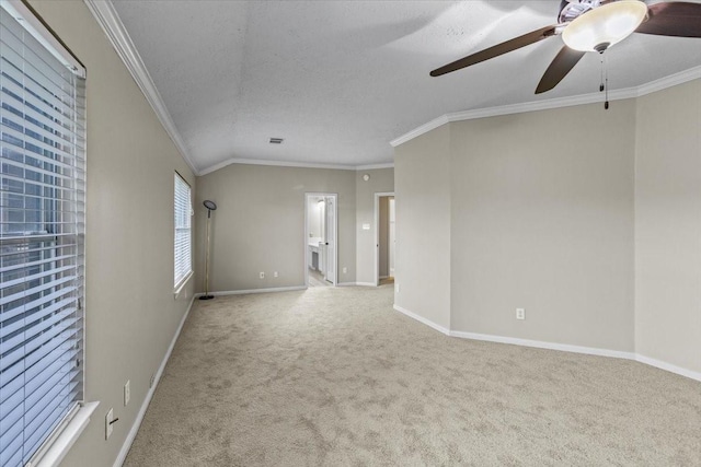 spare room featuring light carpet, baseboards, and crown molding