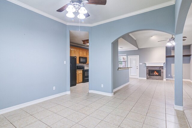 unfurnished living room featuring ceiling fan, ornamental molding, light tile patterned flooring, and baseboards