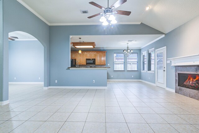 unfurnished living room with light tile patterned floors, visible vents, ornamental molding, a high end fireplace, and ceiling fan with notable chandelier