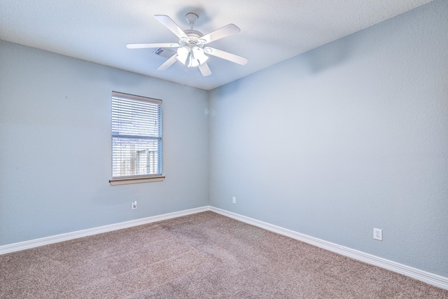 unfurnished room featuring visible vents, carpet floors, a ceiling fan, and baseboards