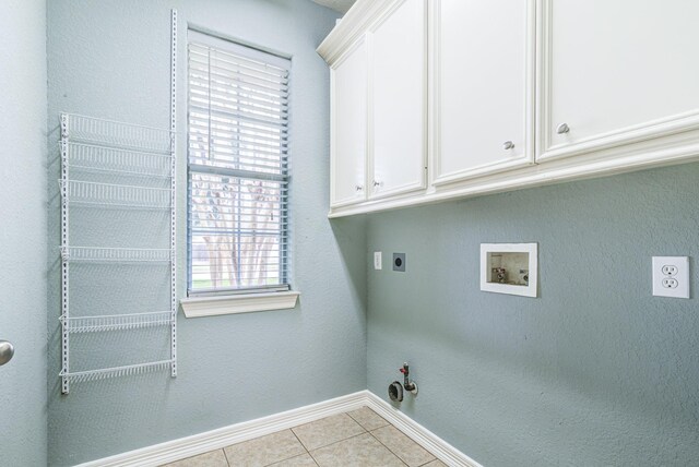 laundry room with cabinet space, light tile patterned floors, hookup for a gas dryer, washer hookup, and electric dryer hookup