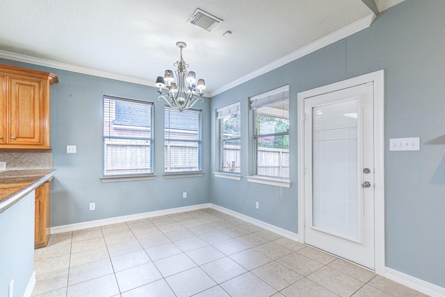 unfurnished dining area with ornamental molding, visible vents, and baseboards