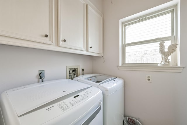 washroom with cabinets and separate washer and dryer