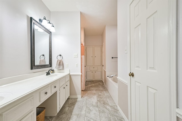 bathroom with a tub to relax in and vanity