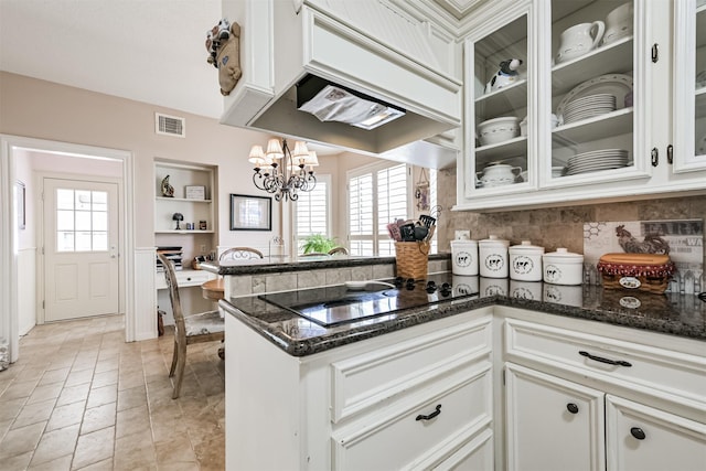 kitchen with white cabinetry, decorative light fixtures, kitchen peninsula, and a healthy amount of sunlight