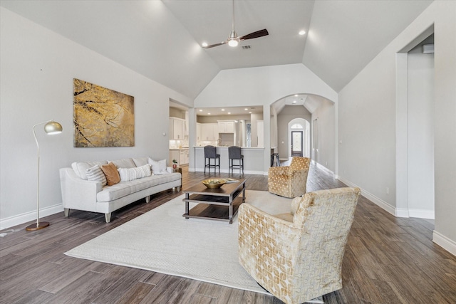 living room featuring ceiling fan, dark hardwood / wood-style floors, and high vaulted ceiling