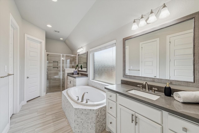 bathroom with vanity, plus walk in shower, and vaulted ceiling