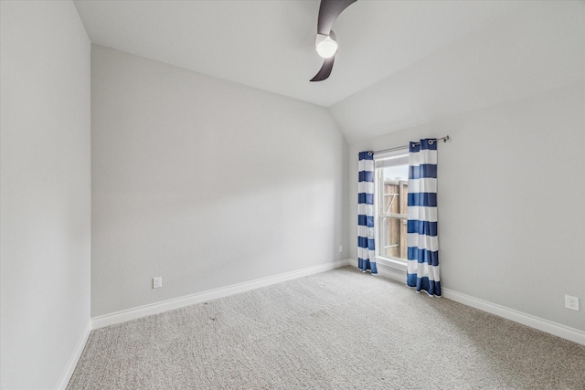 carpeted empty room with ceiling fan and vaulted ceiling