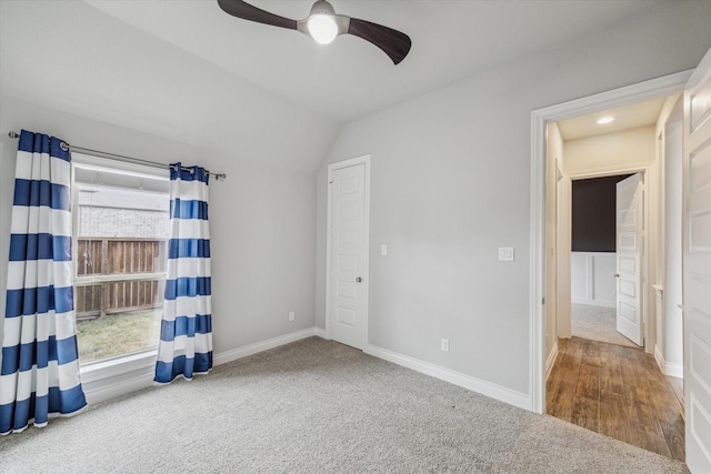 unfurnished bedroom with carpet, lofted ceiling, and ceiling fan