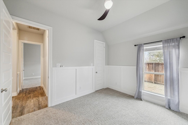 empty room with carpet floors, ceiling fan, and vaulted ceiling