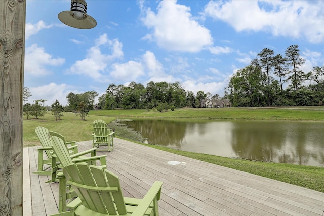 dock area featuring a deck with water view and a yard