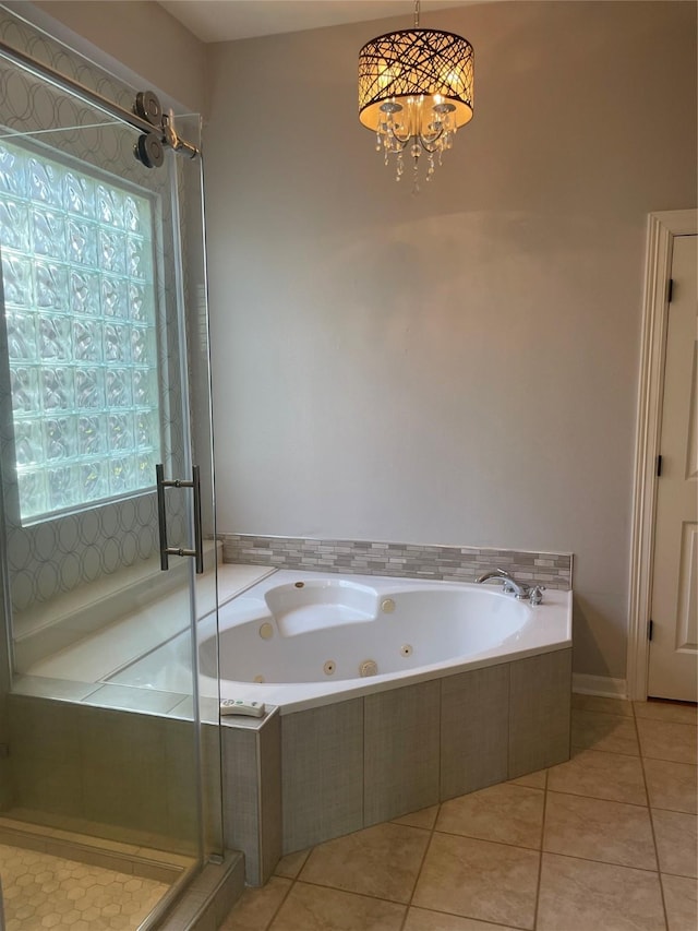 bathroom with a stall shower, a jetted tub, and tile patterned floors