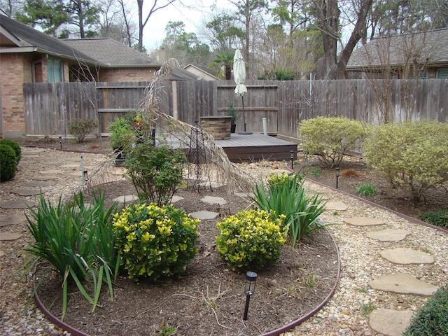 view of yard featuring a deck and fence