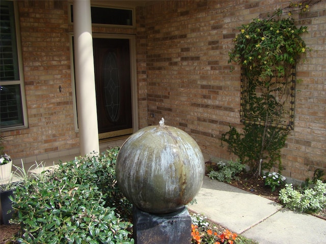 property entrance featuring brick siding