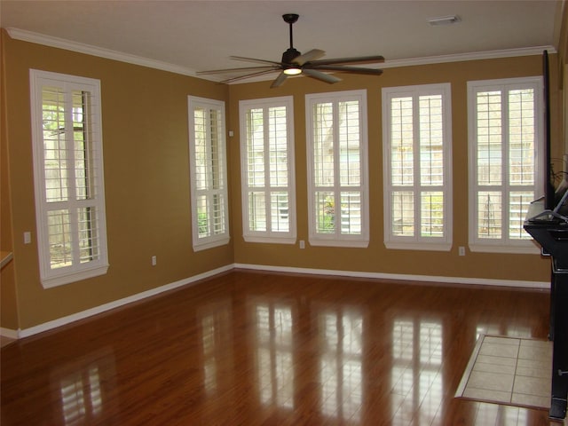 spare room featuring ornamental molding, plenty of natural light, and visible vents