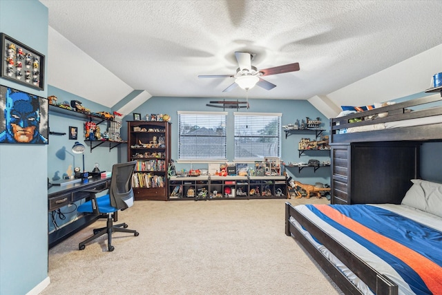 carpeted bedroom with ceiling fan, vaulted ceiling, and a textured ceiling