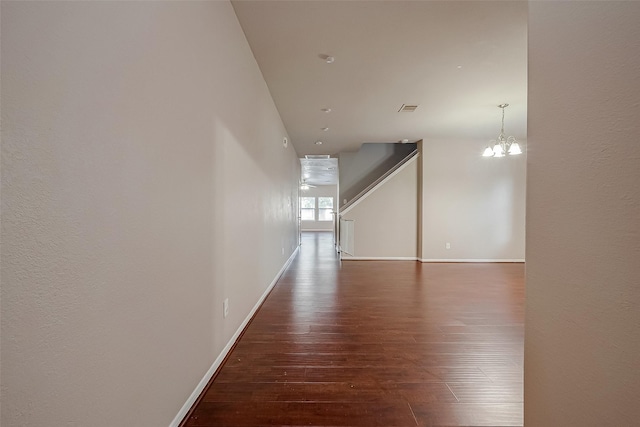 interior space featuring dark hardwood / wood-style floors and a chandelier