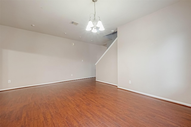 interior space featuring wood-type flooring and a notable chandelier