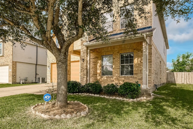 view of front of home with cooling unit and a front lawn