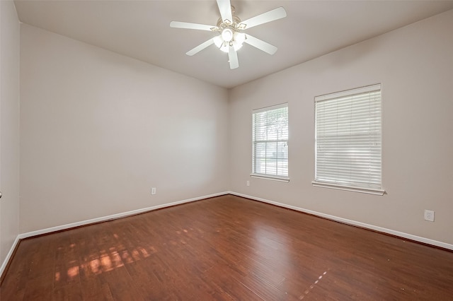 unfurnished room featuring dark wood-type flooring and ceiling fan